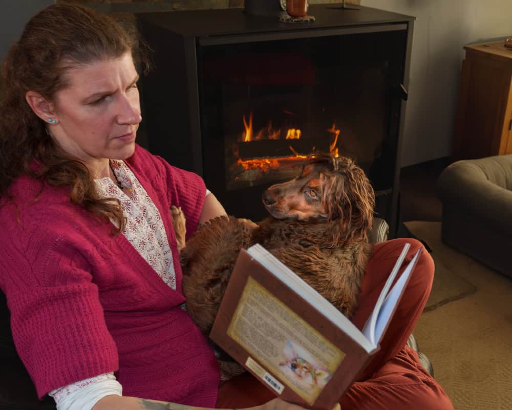Dr Isla Fishburn author of Tunkasila’s Teachings reading to her dog